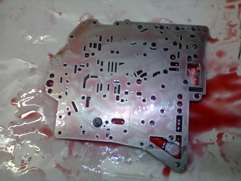The separator plate gets laid over the transfer plate (you can see the screen cone and spring-loaded orifice poking through). Now, we carefully hold the plates together as we flip them upside-down...